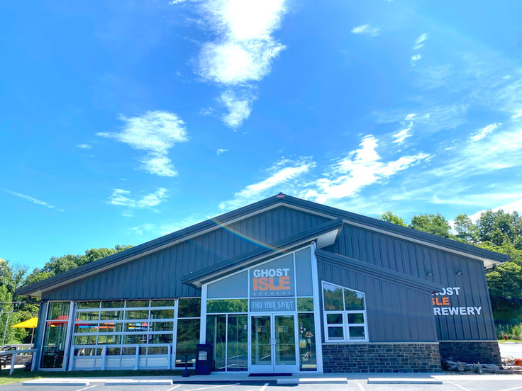 Front facade of brewery with a blue sky. 